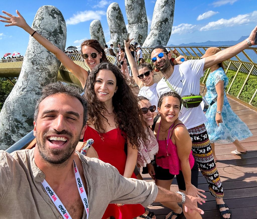 Groupe de voyageurs souriants sur le pont doré de Ba Na Hills lors d’un voyage organisé au Vietnam par WeRoad.