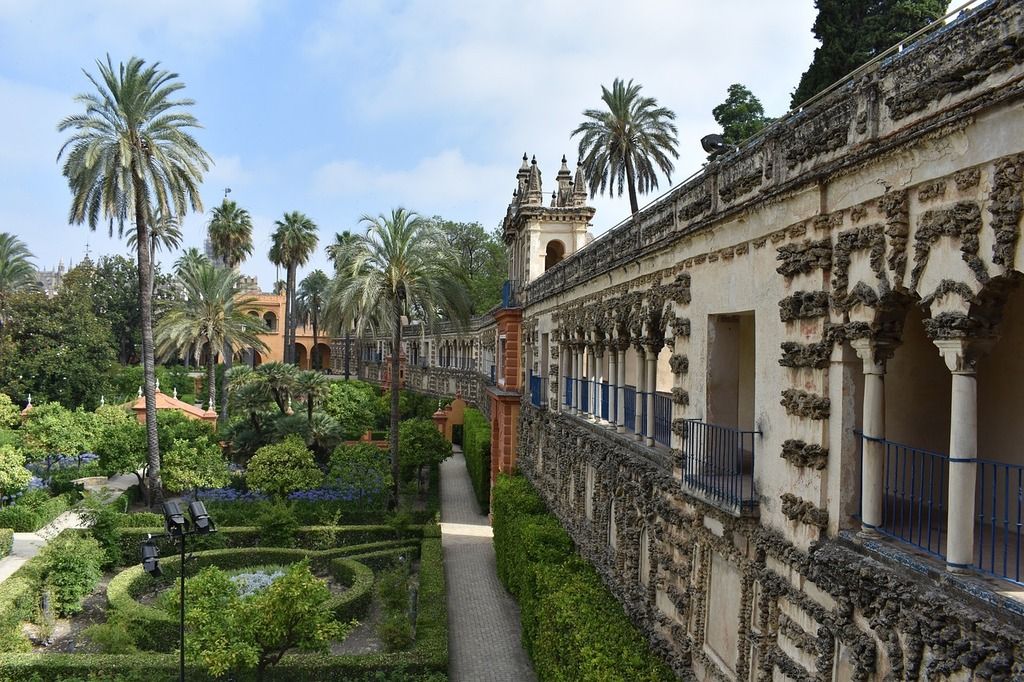 Real Alcázar de Séville: vue des jardins luxuriants et des détails architecturaux du palais.